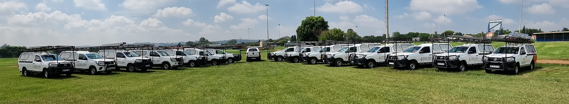 The First Fire Management fleet of branded service vehicles lined up on site
